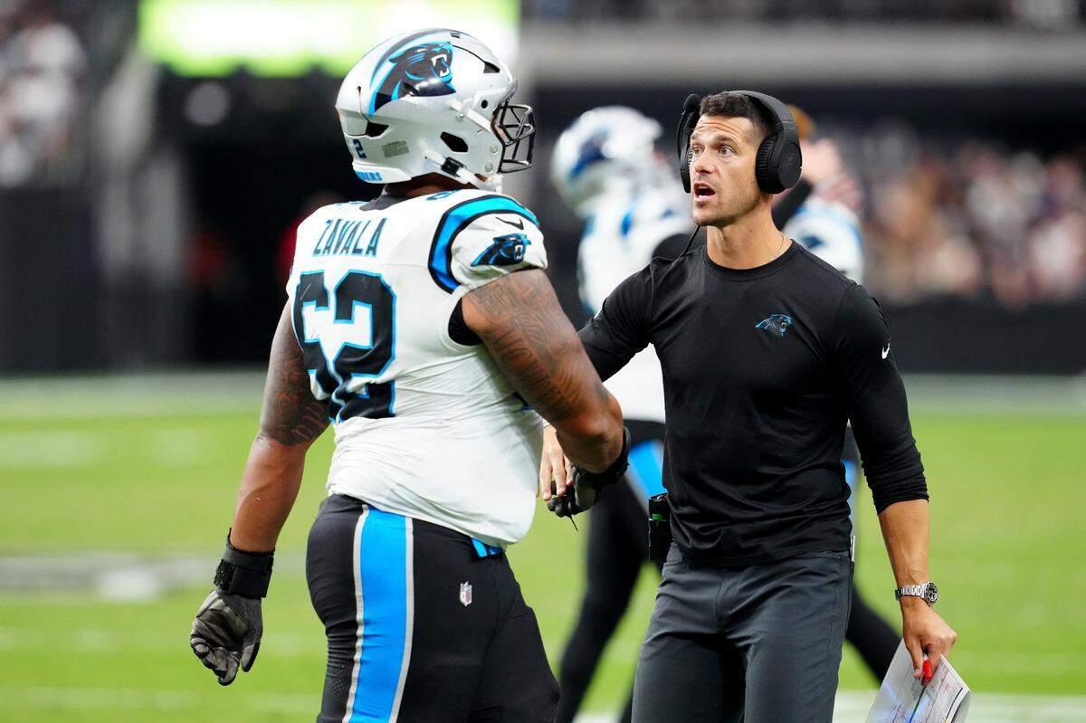 Carolina Panthers head coach Dave Canales congratulates Carolina Panthers guard Chandler Zavala (62) after the Panthers made a play against the Las Vegas Raiders during the fourth quarter at Allegiant Stadium.
