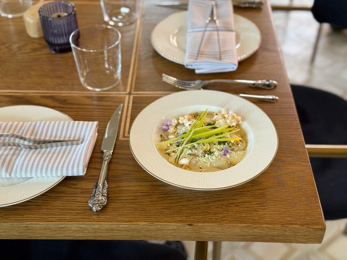Leluia Hall’s Masa & Cheese is topped with popcorn, edible flowers and piquant popcorn shoots.