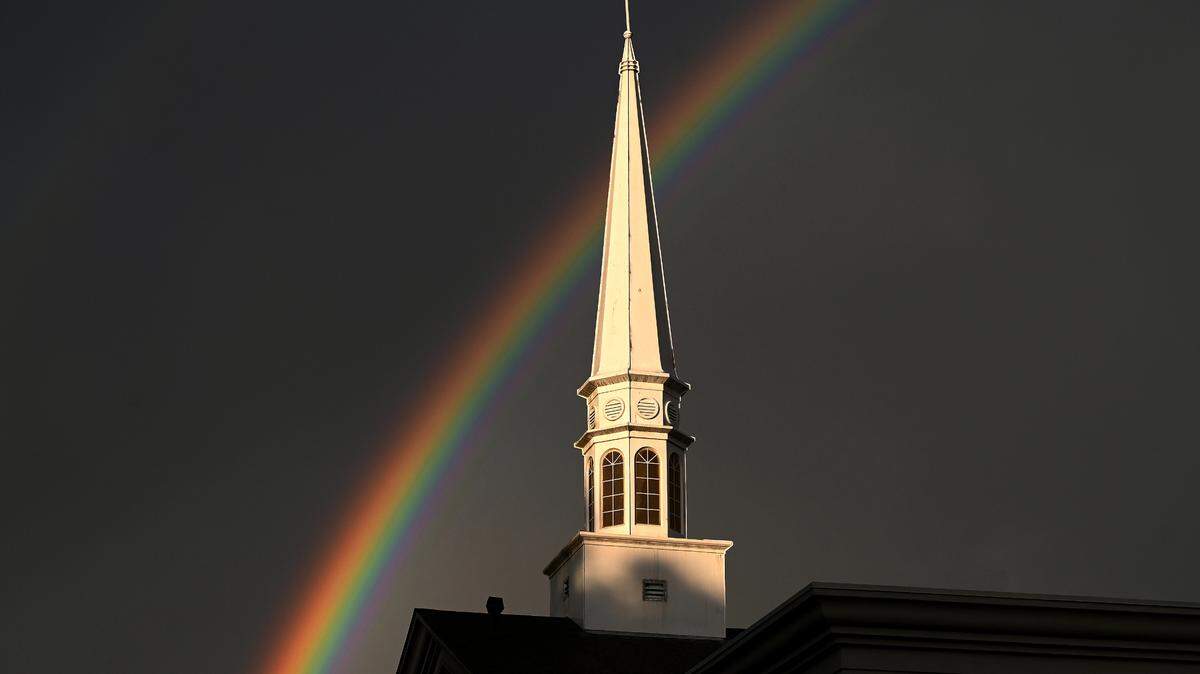 A rainbow serves as the backdrop for the steeple of First Baptist Church of Indian Trail following a spring shower on Thursday, April 10, 2025. By looking closely, a viewer can see that the shower not only produced the rainbow behind the steeple but another very faint rainbow to the far left as the evening sun burst through the gray sky.