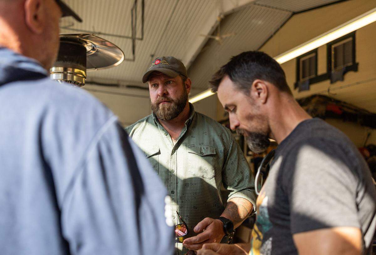 Adam Smith, center, speaks to volunteers at Savage Operations Center inside of a Harley Davidson store in Swannanoa, N.C. on Tuesday, October 8, 2024.