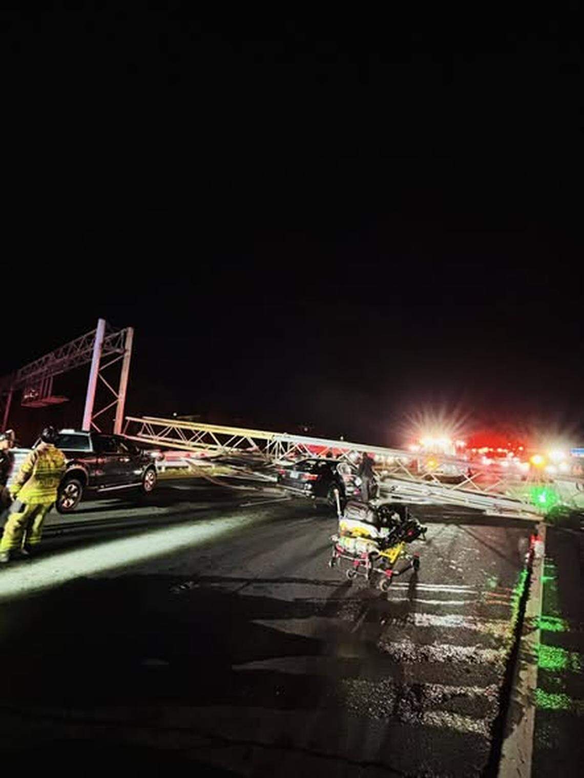 Emergency crews respond to a trapped driver after an overhead sign collapsed onto a car on Interstate 77 South in Charlotte late Friday, Nov. 28, 2025.