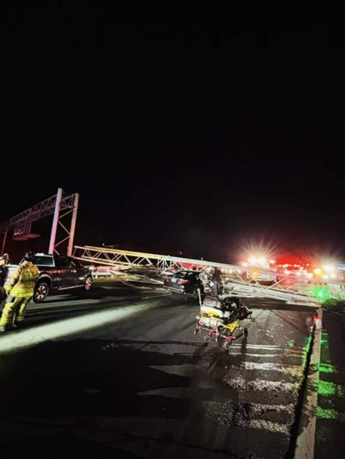 Emergency crews respond to a trapped driver after an overhead sign collapsed onto a car on Interstate 77 South in Charlotte late Friday, Nov. 28, 2025.