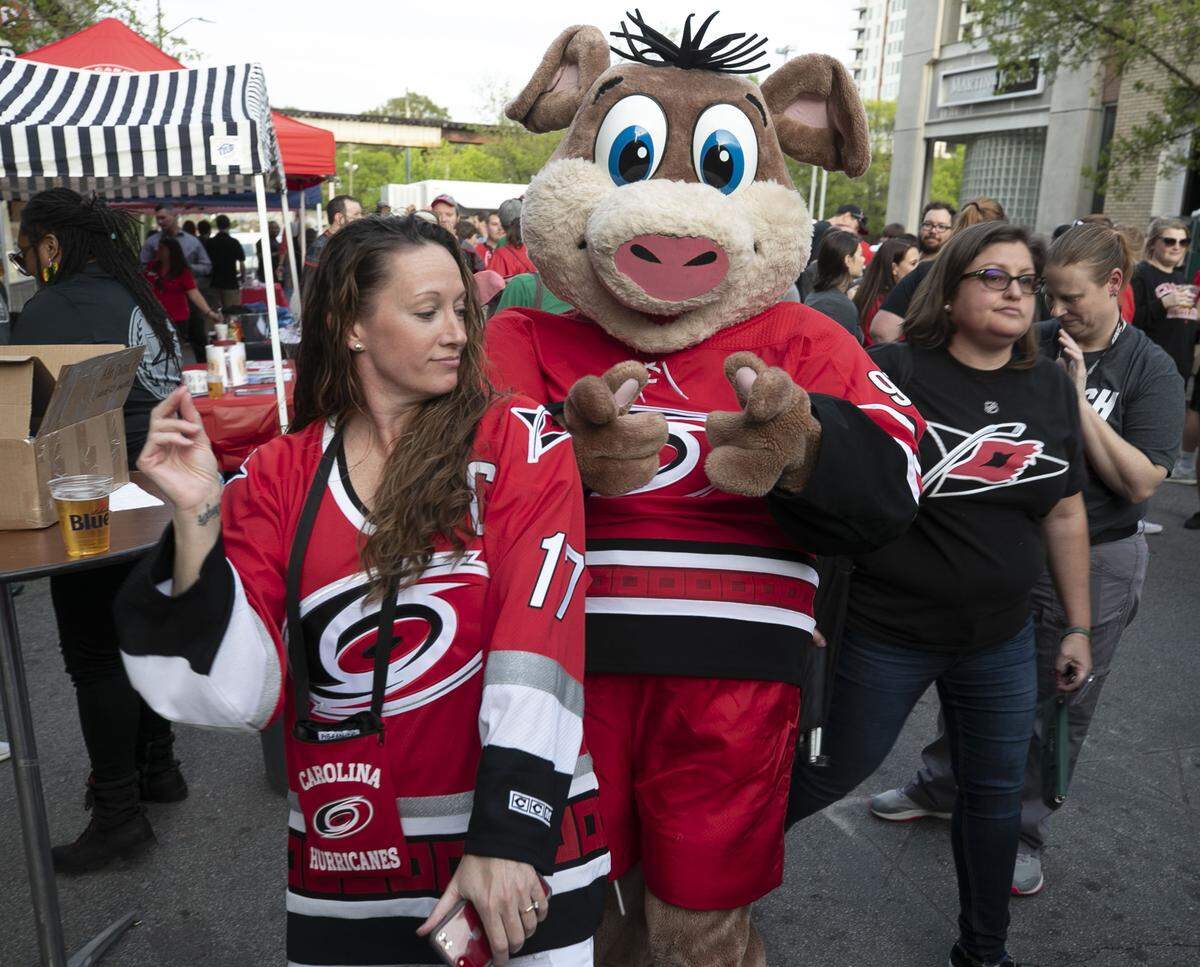 Stormy, the Carolina Hurricanes' mascot dances with Tabitha Brown of Raleigh during a street party on Tucker Street in the Glenwood South neighborhood prior to the Hurricanes' first round game of the Stanley Cup playoffs against Washington on Thursday, April 11, 2019 in Raleigh, N.C. 