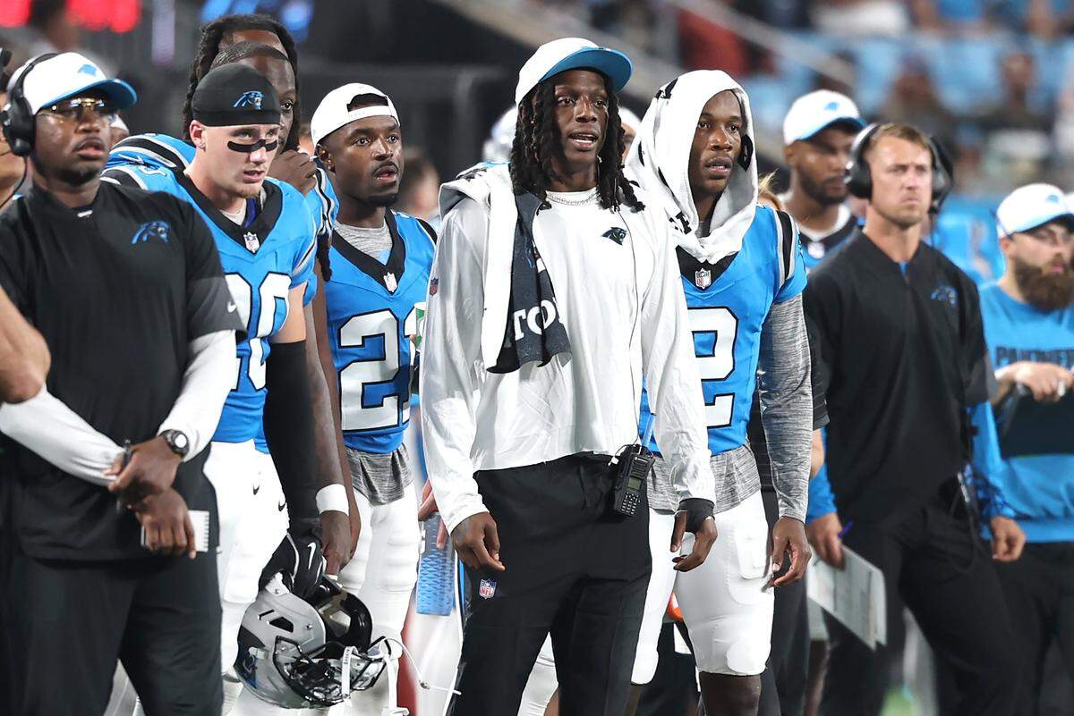 Injured Carolina Panthers cornerback Jaycee Horn, center, stands with his teammates during action against the Cleveland Browns on Aug. 8, 2025, at Bank of America Stadium in Charlotte.