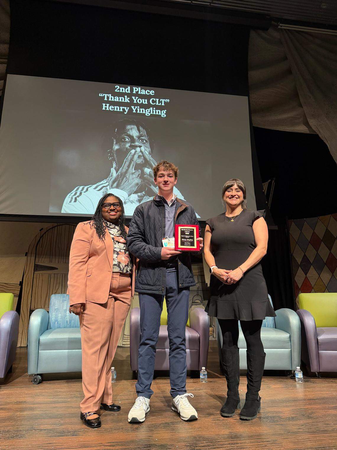 Henry Yingling, center, a student at Myers Park High School, is honored as the second place winner of the student photo contest for his photo, “Thank You CLT”, during The Charlotte Observer’s third annual Captured Memories event at ImaginON: The Joe and Joan Martin Theater in Charlotte on Wednesday, January 14, 2026.