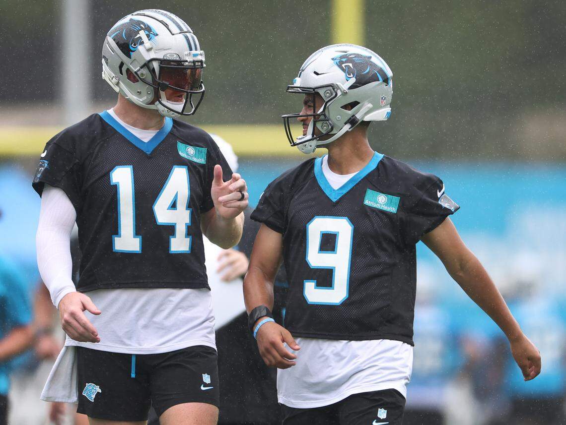 Carolina Panthers quarterbacks Andy Dalton, left and Bryce Young, right, talk prior to beginning a new series of drills during practice on Thursday, July 25, 2024.