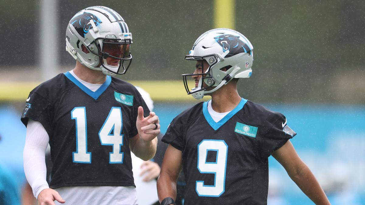 Carolina Panthers quarterbacks Andy Dalton, left and Bryce Young, right, talk prior to beginning a new series of drills during practice on Thursday, July 25, 2024.