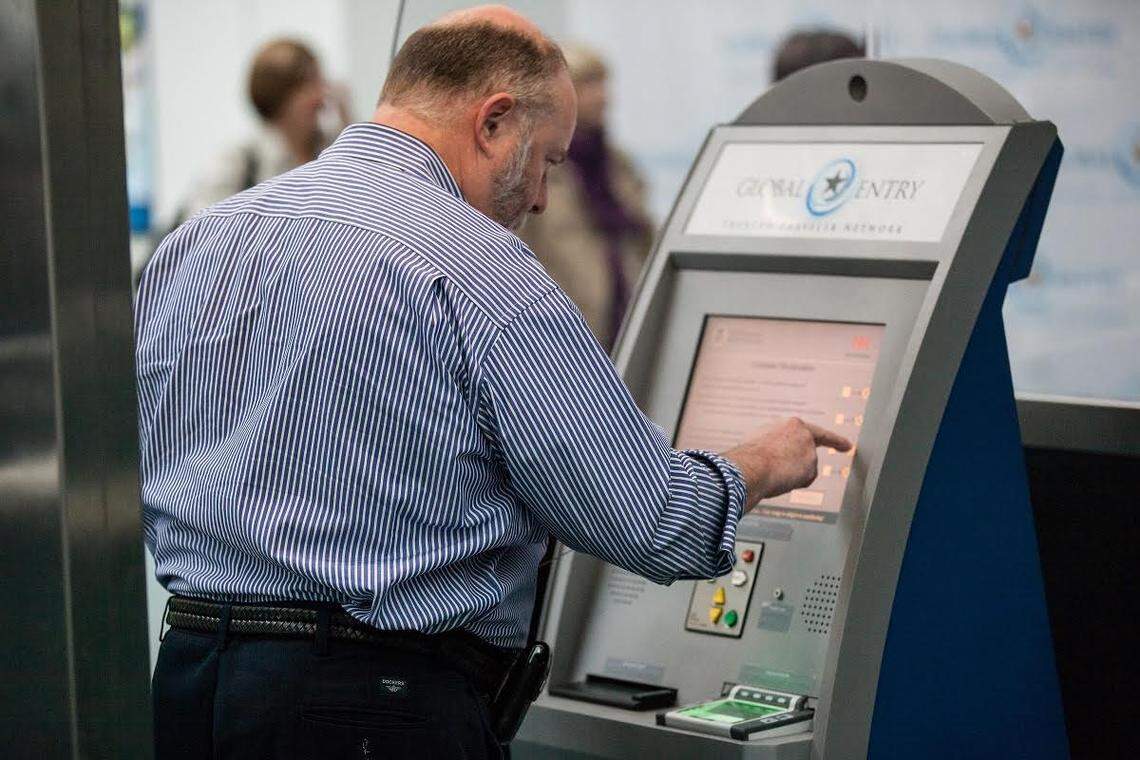 Man using a new Global Entry kiosk at Newark Liberty International Airport. 