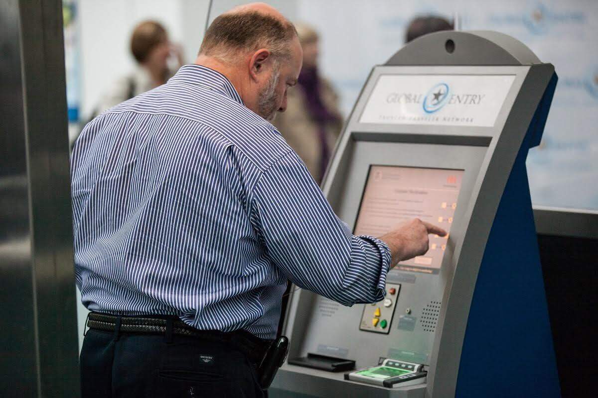 Man using a new Global Entry kiosk at Newark Liberty International Airport.