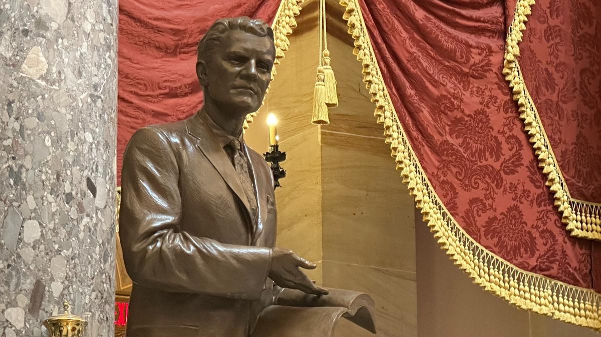 A close-up of the statue of the late Rev. Billy Graham that was unveiled May 16, 2024 and stands in the U.S. Capitol in Washington, D.C. Graham is holding a Bible, open to Galatians 6:14.
