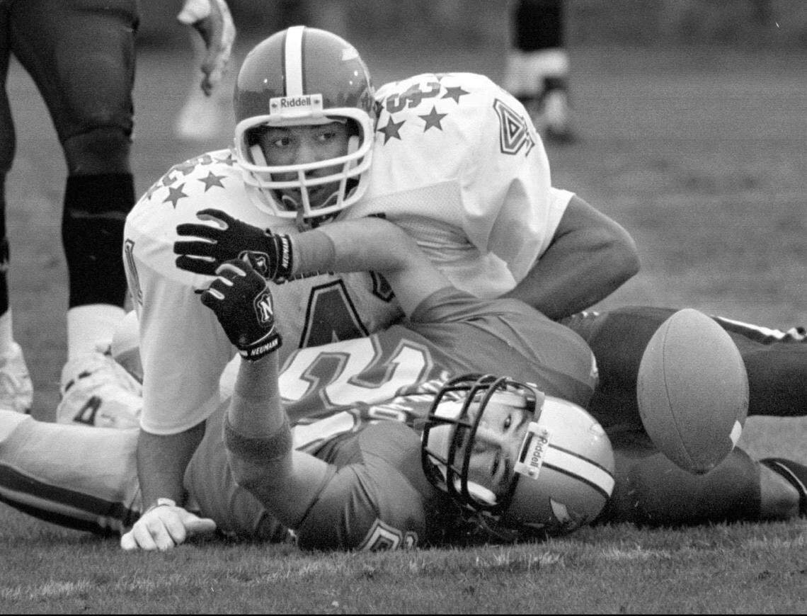 Wide receiver Jammie Deese of Scotland, N.C., playing for North Carolina high school football all-stars, can't hang on to a pass after he's hit by South Carolina linebacker Anthony Simmons of Spartanburg during the 1994 Shrine Bowl. 