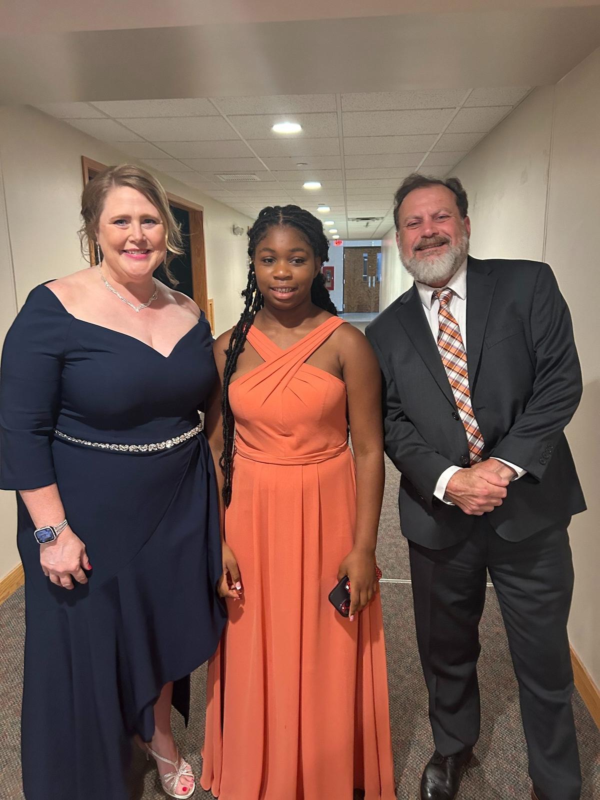 Nola Tate, with family friends Wendy and John Marus.