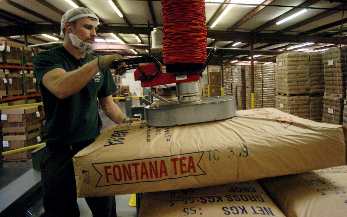 Chuck Johnston, a tea dumper, loads a blend of tea which will be put in a mixer to be transferred to a bin at S&D in Concord on Feb. 15, 2007. 
