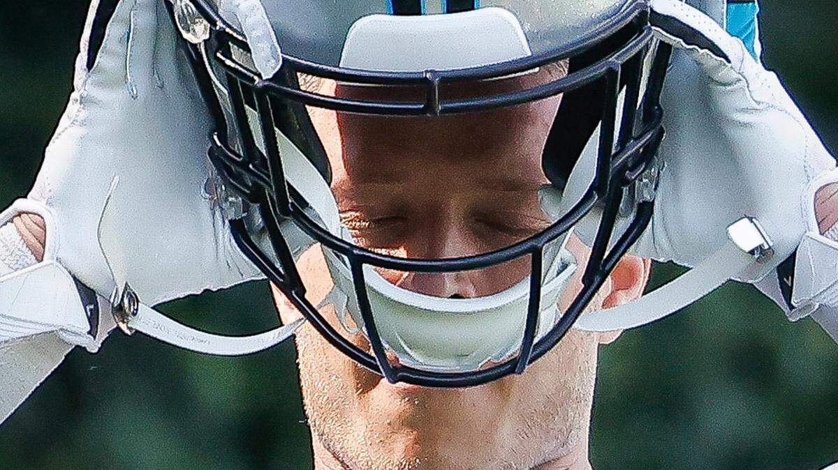 Carolina Panthers running back Christian McCaffrey (22) adjusts his helmet during the teams training camp practice at Wofford College in Spartanburg, S.C., Thursday, July 28, 2022.