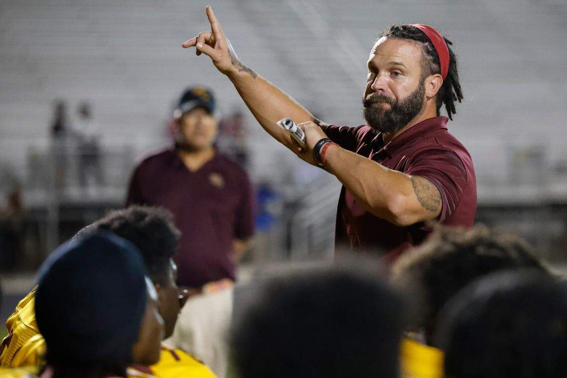 West Charlotte’s head coach Sam Greiner speaks to the team after a game against Garinger at Waddell High School in Charlotte, N.C., Thursday, Sept. 8, 2022. West Charlotte beat Garinger 48-8.