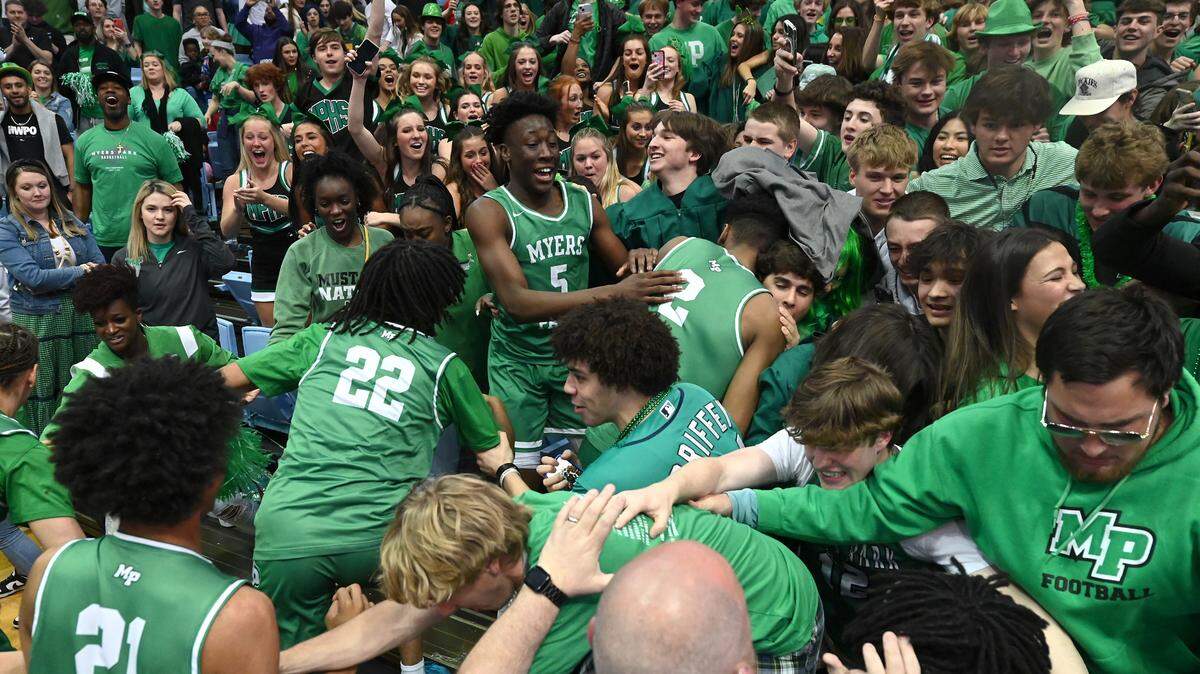 Members of the Myers Park basketball team run into the stands to celebrate with their fans following the teams 74-60 victory over Richmond Senior in the NCHSAA state 4A championship game at the Dean Smith Center on Saturday, March 11, 2023.