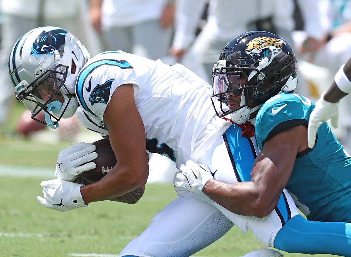 Carolina Panthers wide receiver Tetairoa McMillan, left, catches a pass from quarterback Bryce Young as Jacksonville Jaguars cornerback Tyson Campbell, right, makes the tackle during action on Sunday, September 7, 2025, at Everbank Stadium in Jacksonville, Florida.