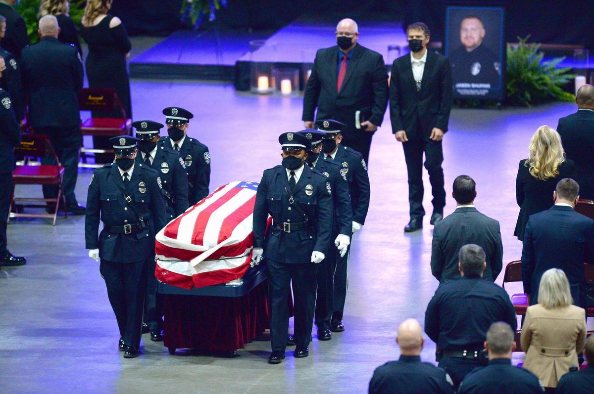 A Honor Guard leads the casket of fallen Concord police officer Jason Shuping down an aisle at the Cabarrus Arena and Events Center on Tuesday, December 22, 2020. Officer Shuping was killed in the line of duty last week. The officer was responding to an attempted carjacking outside a fast food restaurant near Concord Mills.