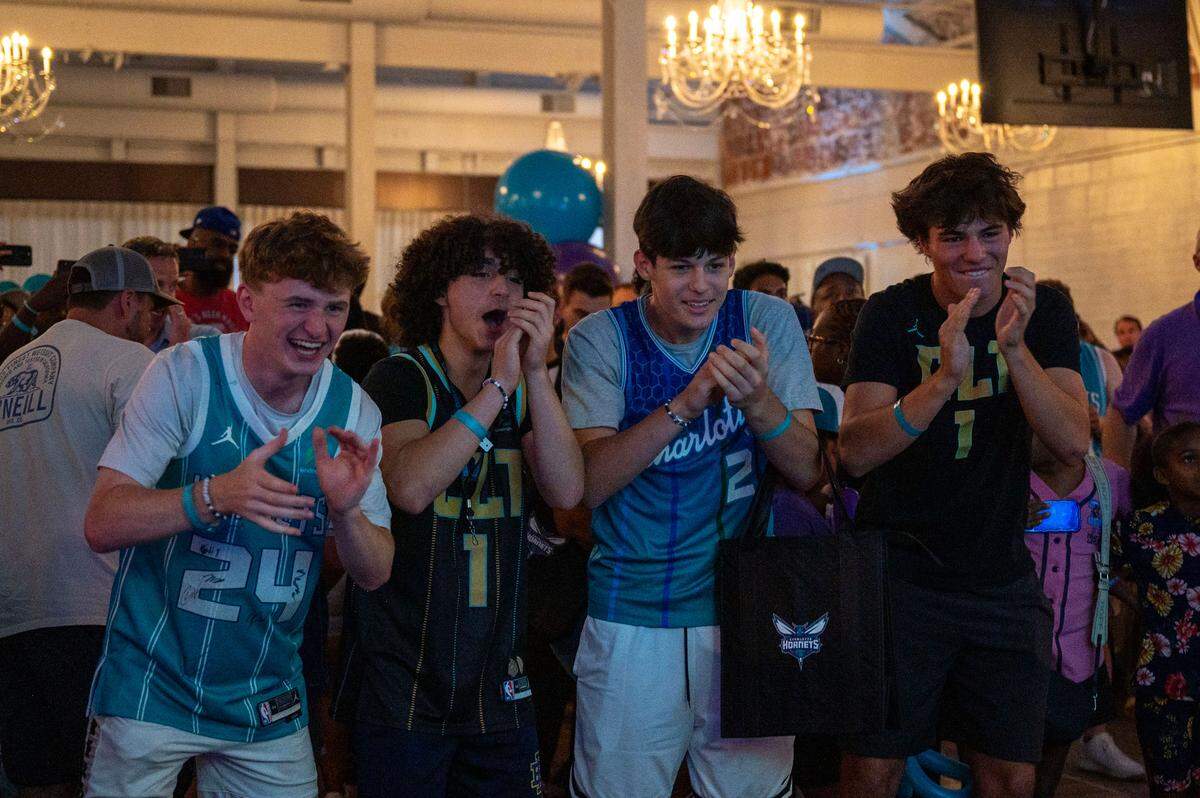 Charlotte Hornets fans James Brinkley, Bora Eskinazi, Rocco Taddeo and Henrique Lima (left to right) cheer after the selection of Duke’s of Kon Knueppel at the team’s draft party on Wednesday night.