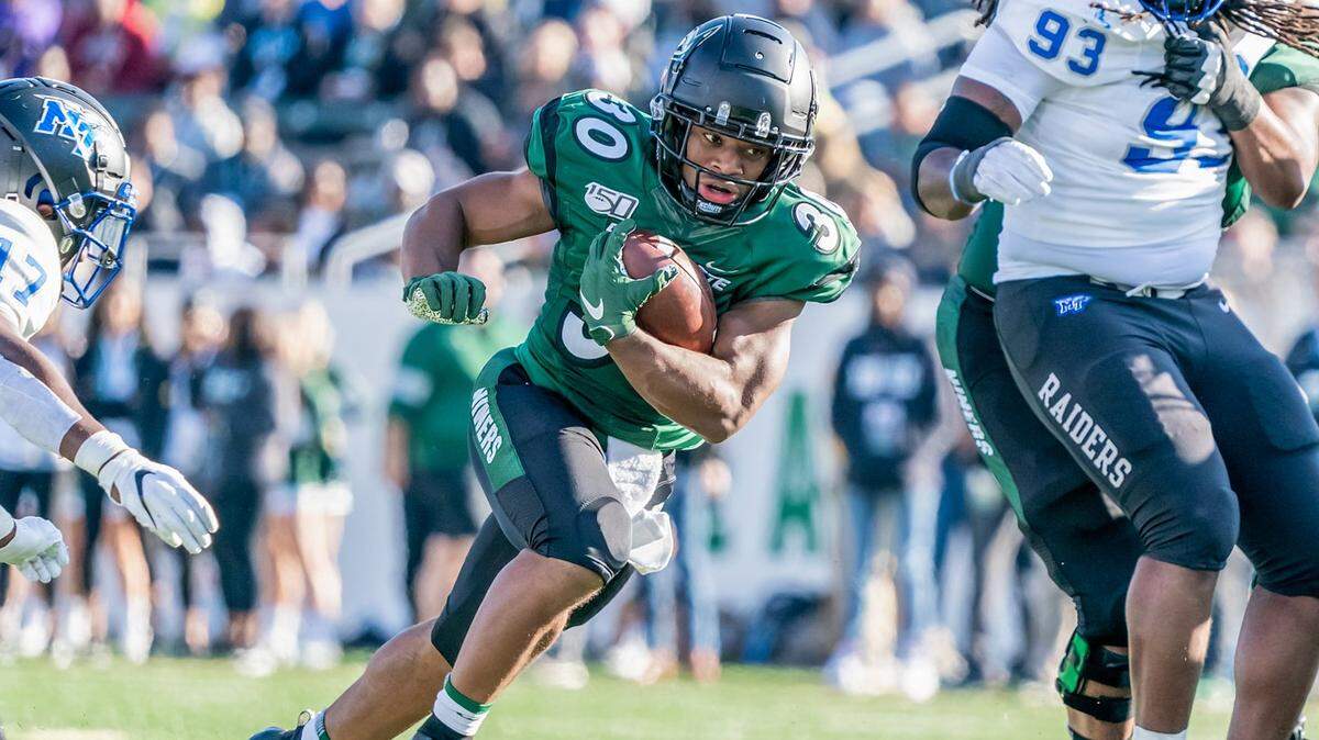 Charlotte’s Ishod Finger (30) picks up yardage against Middle Tennessee on Saturday.