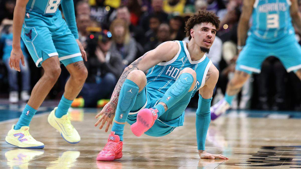 Charlotte Hornets guard LaMelo Ball, center, jumps back to his feet after falling to the court as he backpedaled downcourt. Ball would trip over Los Angeles Lakers forward Jarred Vanderbilt and leave the game with a sprained left ankle during action at Spectrum Center in Charlotte, NC on Monday, January 27, 2025.