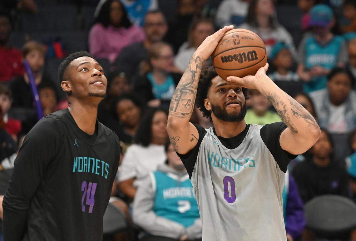 Charlotte Hornets rookie forward/guard Brandon Miller, left, watches forward Miles Bridges, right, shoot three-point shots during a competition at the team’s Purple and Teal scrimmage at Spectrum Center in Charlotte, NC on Saturday, October 7, 2023.