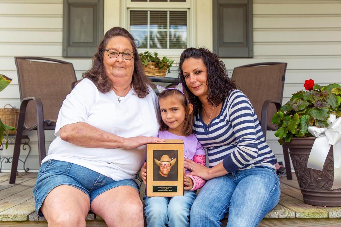 From left, Teresa, Kensley, and Kelli Kersey sit for a portrait outside home after an interview about Darrell Kersey, their husband, grandfather and father, who died of complications from COVID-19 which he tested positive for while incarcerated in the Durham County jail, on Thursday, Oct. 22, 2020, in High Point, N.C.