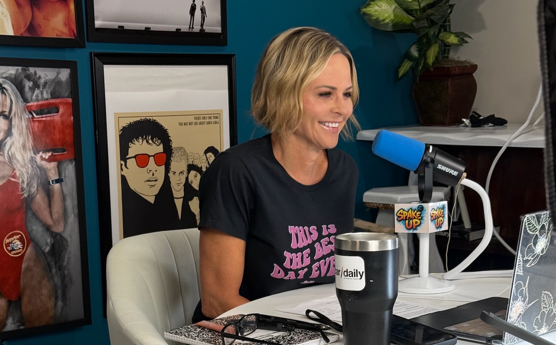 Shannon Spake sits at the microphone during a taping of her “Spake Up Podcast.”