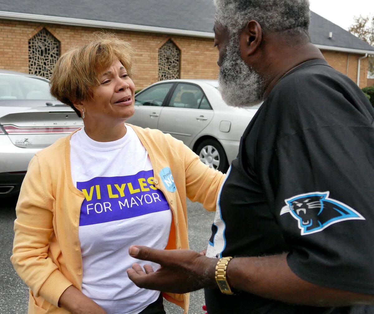 Charlotte Mayoral candidate Vi Lyles greets voter Warren O. Stukes Sr. outside East Stonewall  AME Zion Church early Tuesday morning, November 7, 2017. 