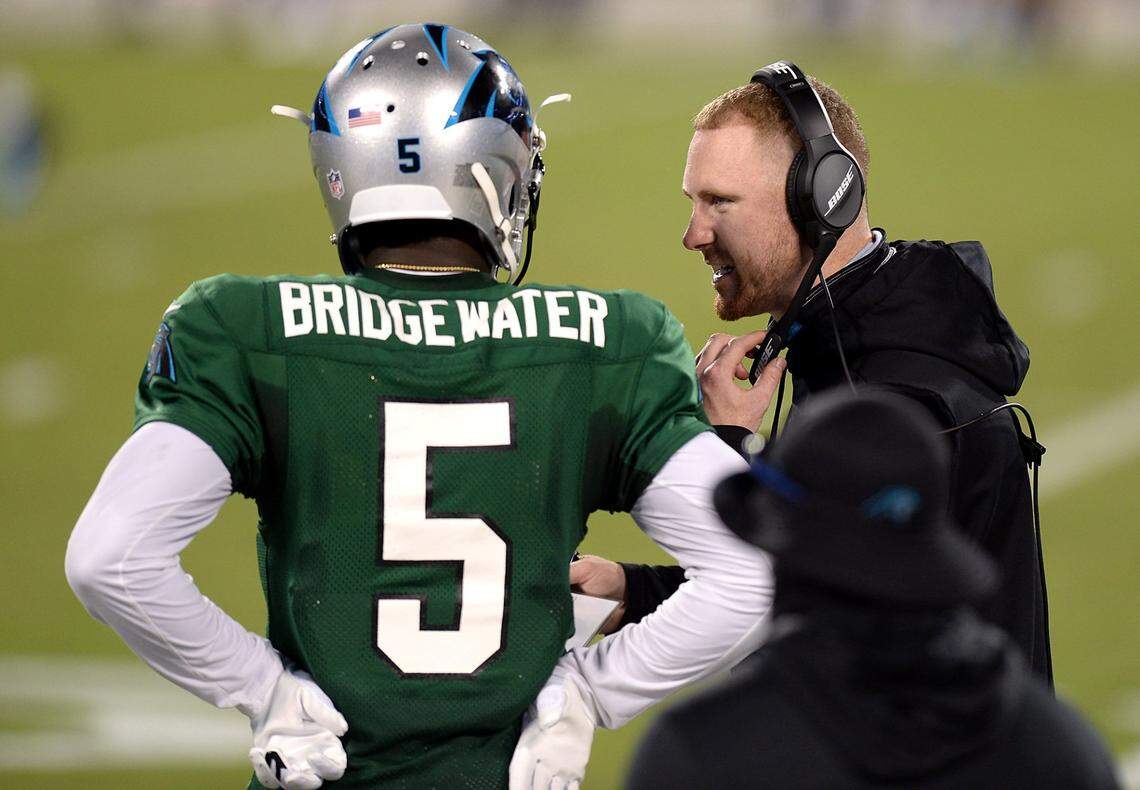 Carolina Panthers quarterback Teddy Bridgewater, left, talks with offensive coordinator Joe Brady, right, during practice at Bank of America Stadium on Wednesday, August 26, 2020.