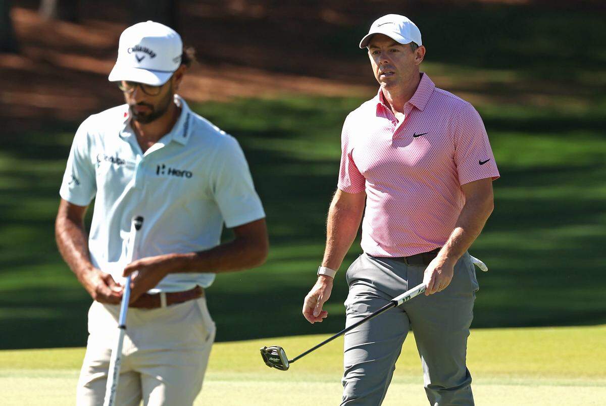 Rory McIlroy, right, walks to the second green with golfer Akshay Bhatia, left, during the final round of the Truist Championship at Quail Hollow Club in Charlotte, NC on Sunday, May 10, 2026.