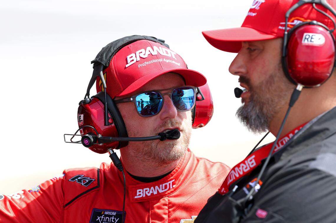 NASCAR Xfinity Series driver Justin Allgaier, left, speaks with a member of his team, right, prior to qualifying for the North Carolina Education Lottery 250 at Rockingham Speedway on Saturday, April 19, 2025.