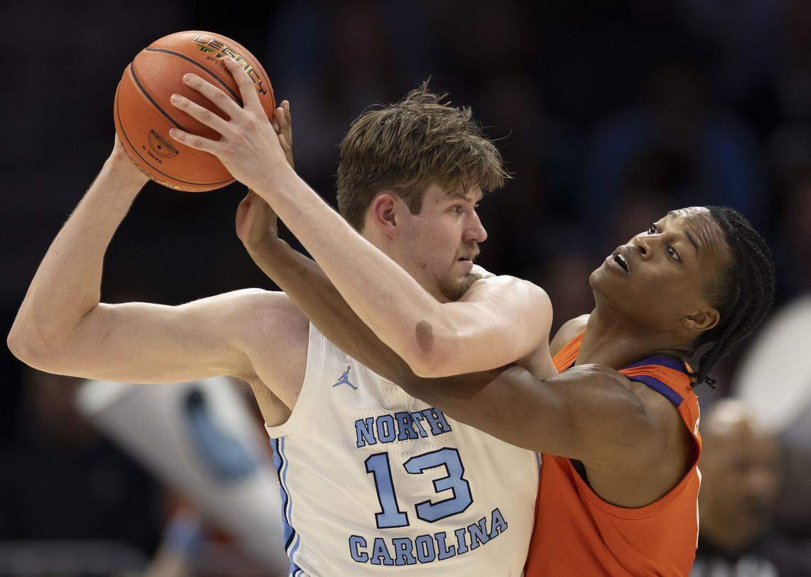 Clemson forward R J Godfrey (0) defends North Carolina center Henri Veesaar (13) in the first half on Thursday at Spectrum Center. Veesaar ended with career highs in points (28) and rebounds (17).