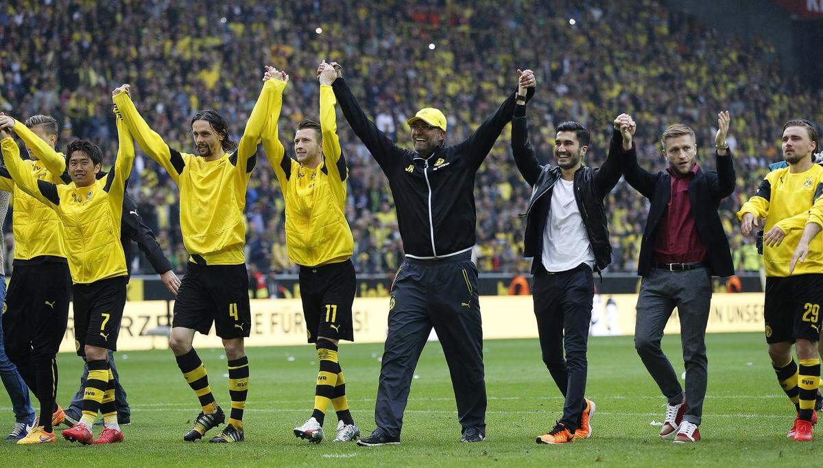 Dortmund’s head coach Juergen Klopp , center, celebrates with his team after  the German first division Bundesliga soccer match between BvB Borussia Dortmund  and Werder Bremen in Dortmund, Germany, Saturday, May 23, 2015. (AP Photo/Frank Augstein)