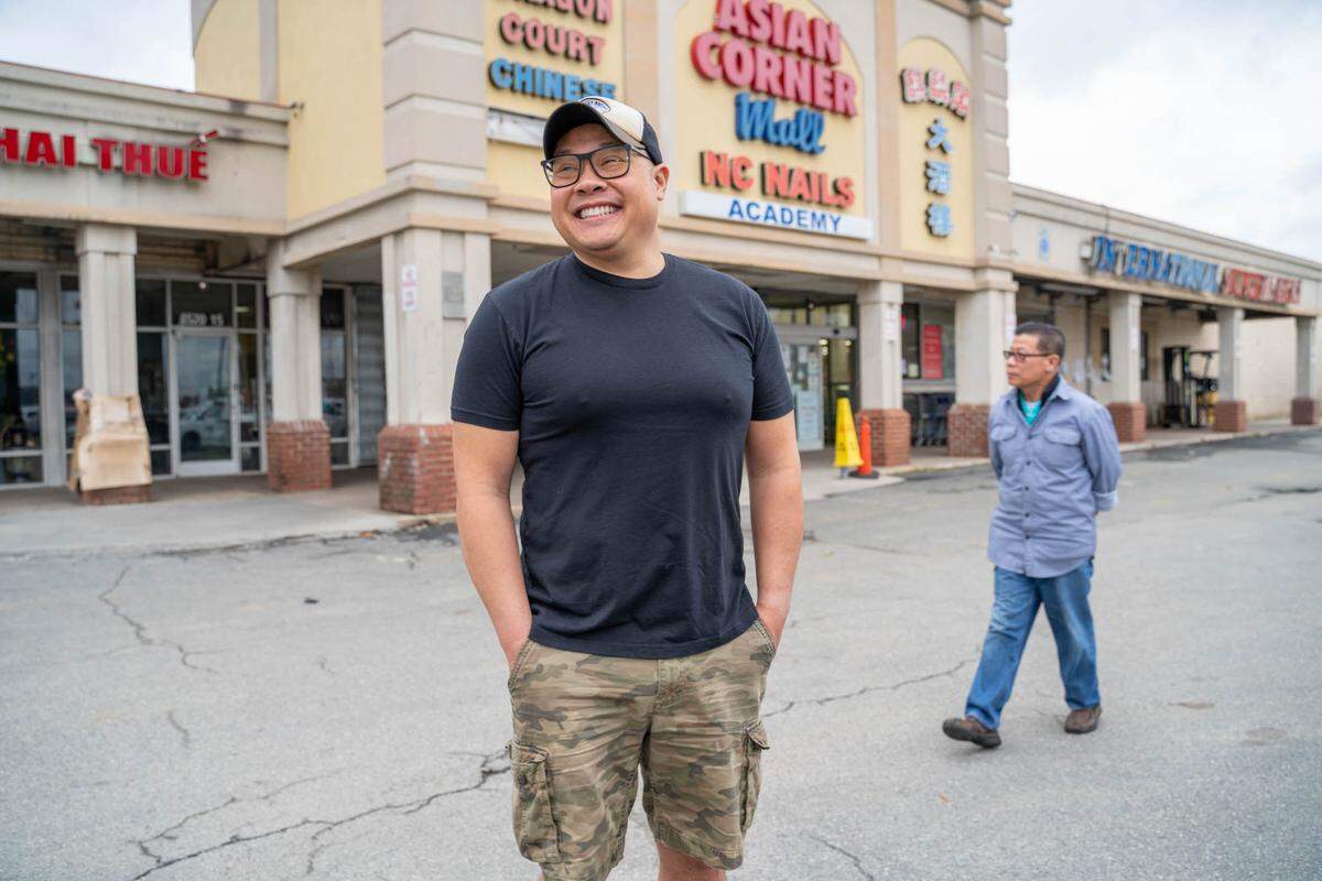 Tuan Nguyen smiles as his father, Minh Quang Nguyen, surveys the landscape at Asian Corner Mall. Le’s Sandwiches & Cafe owners Minh and Le Thi Le-Nguyen put the restaurant up for sale to make way for retirement. Then their son, Tuan, decided to take over, with a plan to move to a nearby spot as the family’s lease at Asian Corner Mall comes to an end.