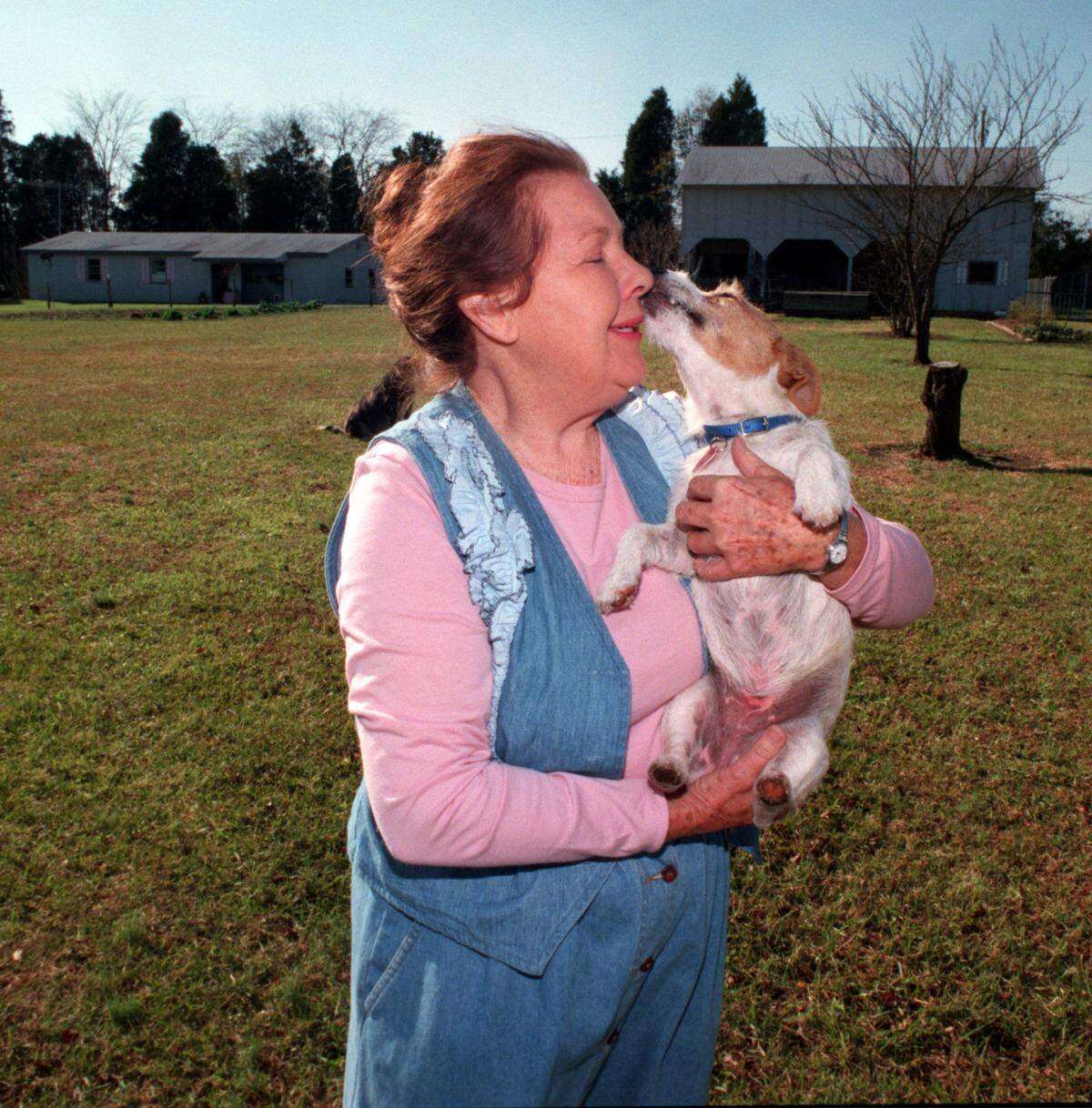 In this August 2005 Charlotte Observer file photo, Ruth Threatt gets kisses from Pound Cake, her Jack Russell terrier.