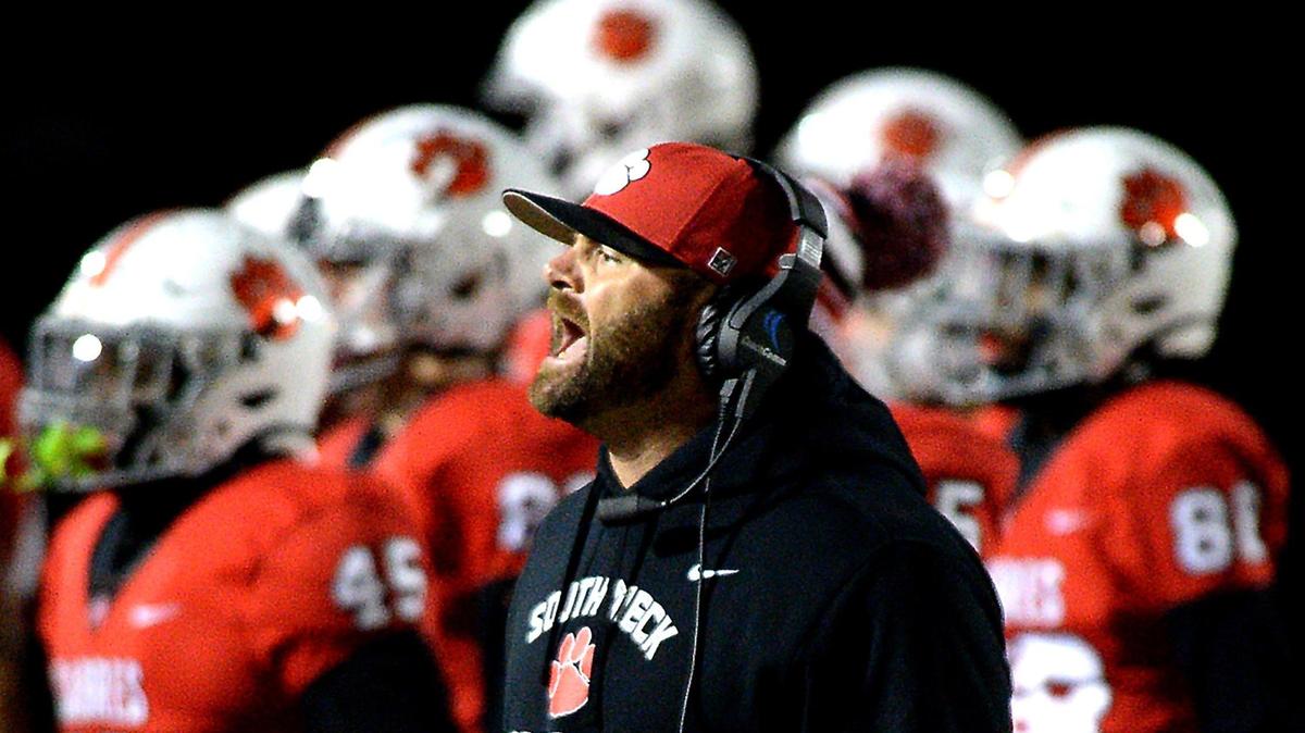 South Meck Sabres head coach Joe Evans, center, yells instructions back to the bench during second quarter action against the West Forsyth Titans at South Meck High School in Charlotte, NC on Friday, November 5, 2021.