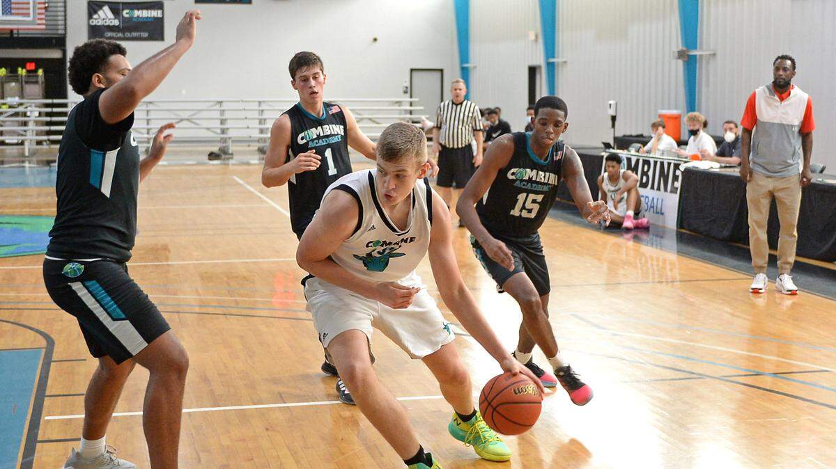 Combine Academy center Patrick Wessler, center, drives to the basket during a practice game at Combine Academy in Lincolnton, NC on Wednesday, October 21, 2020.