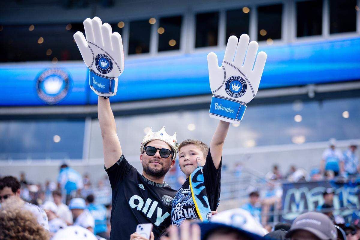 Apr 5, 2025; Charlotte, North Carolina, USA; Charlotte FC fans celebrate before a match between the Charlotte FC and the Nashville SC at Bank of America Stadium. Mandatory Credit: Scott Kinser-Imagn Images