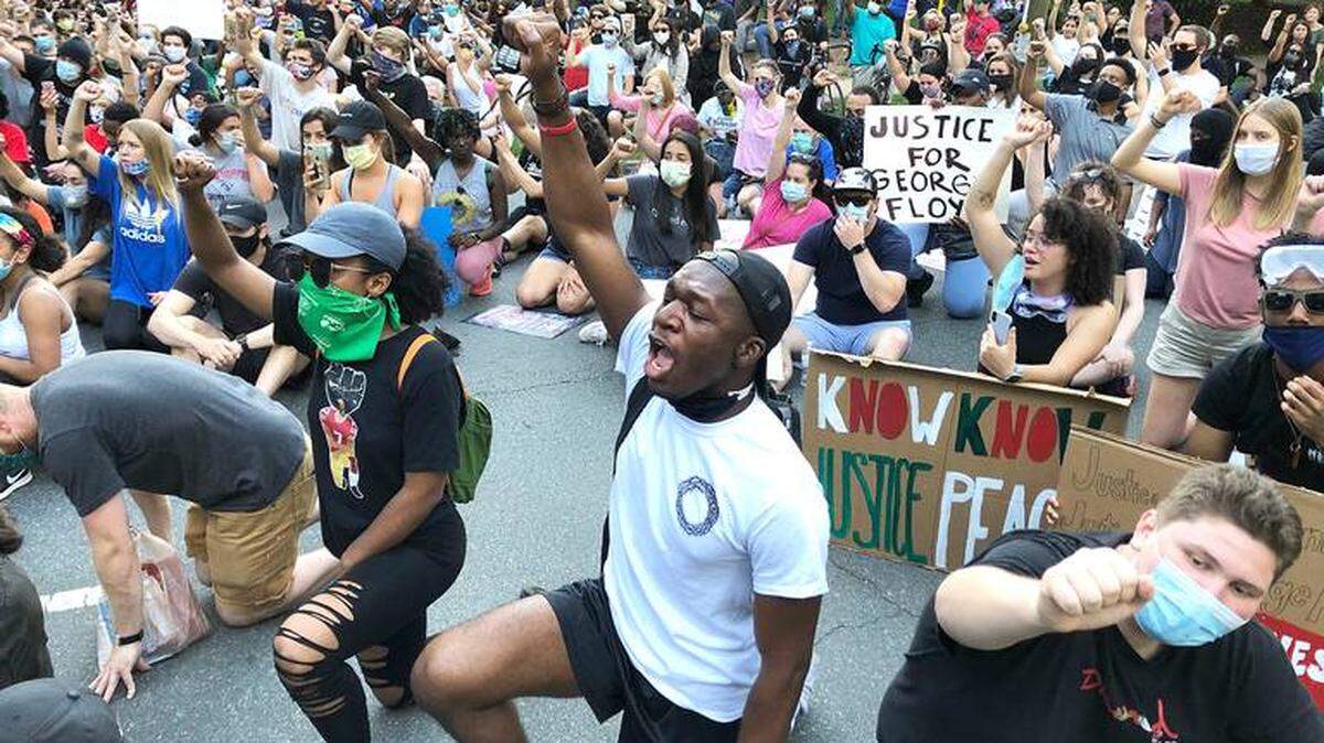 Hundreds of demonstrators who marched through upscale Charlotte on Monday took a knee or sat at an Myers Park intersection for nine minutes, the same amount of time Minneapolis Officer Derek Chauvin had his knee on George Floyd’s neck.  