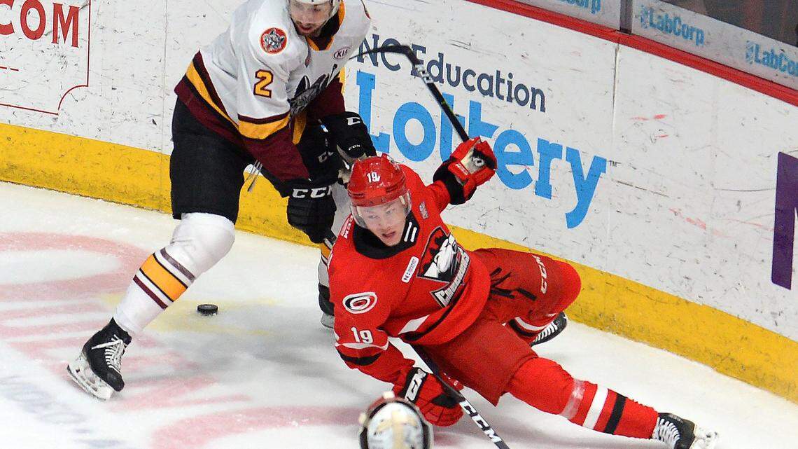 Charlotte Checkers center Morgan Geekie, right, falls to the ice while battling Chicago Wolves Nic Hague, left, for the puck during first period action on Sunday, June 2, 2019 at Bojangles’ Coliseum in Charlotte, NC.