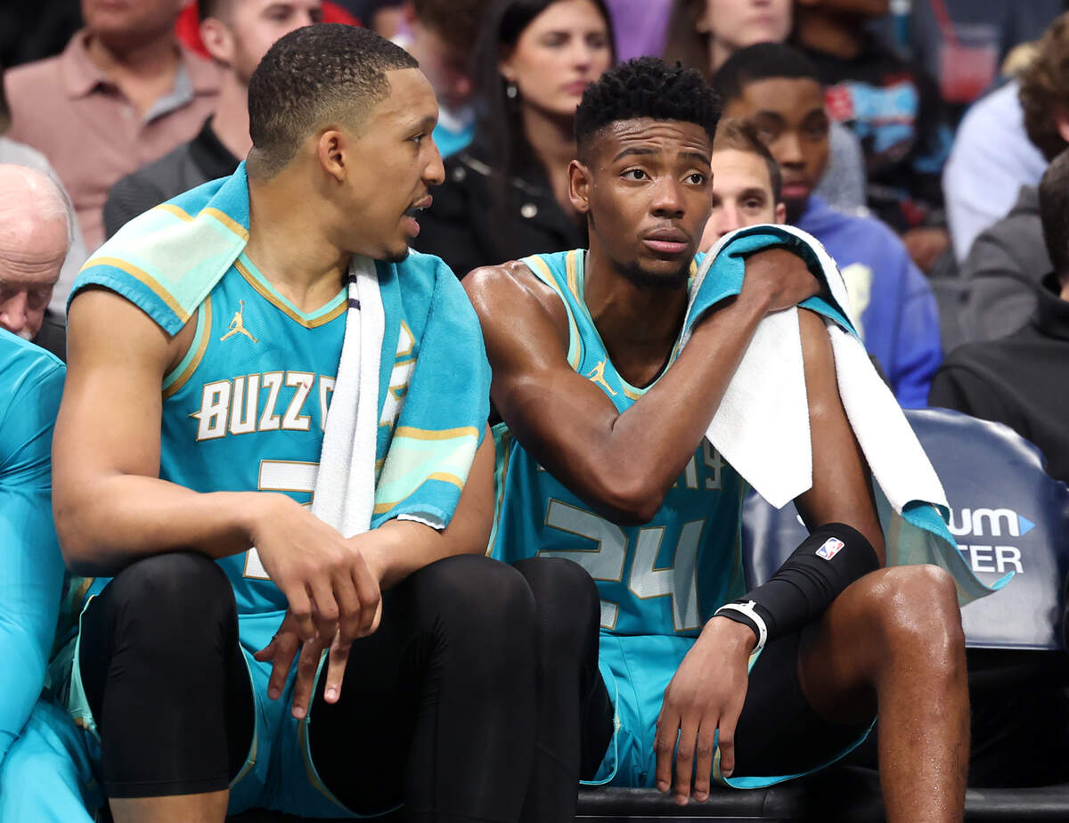 Charlotte Hornets forward Grant Williams, left, talks to forward/guard Brandon Miller, right, on the bench during first-half action against the Dallas Mavericks at Spectrum Center in Charlotte, NC on Tuesday, April 9, 2024. The Mavericks defeated the Hornets 130-104.