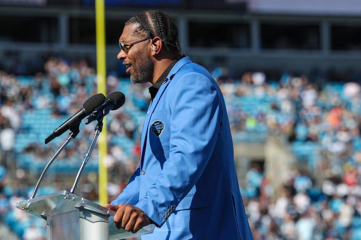 Panthers legend Julius Peppers delivers remarks at his Hall of Honor induction ceremony during halftime of Texans at Panthers at Bank of America Stadium on Sunday, October 29, 2023. Peppers will now trade that blue jacket for a gold one, symbolic of his enshrinement into the Pro Football Hall of Fame in August.