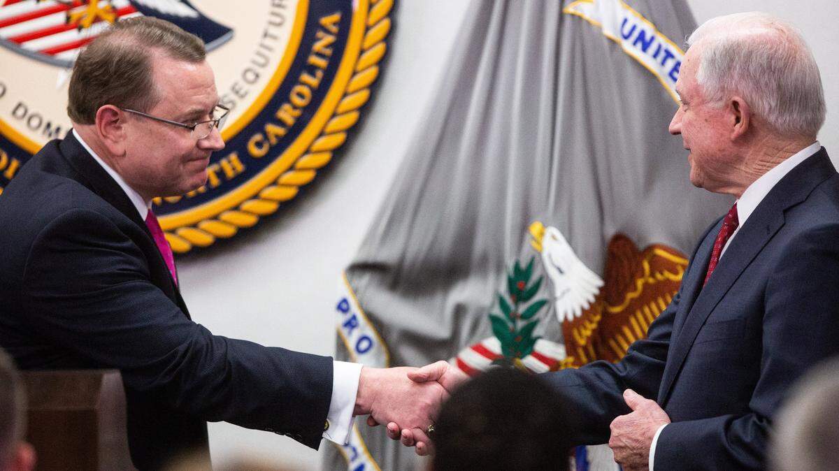 U.S. Attorney Robert Higdon, left, shown here with then Attorney General Jeff Sessions, is targeting a handful of noncitizens for voting.