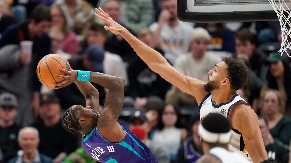 Utah Jazz center Rudy Gobert, right, defends Charlotte Hornets guard Terry Rozier on Monday night in Salt Lake City. The Jazz won, 112-102.