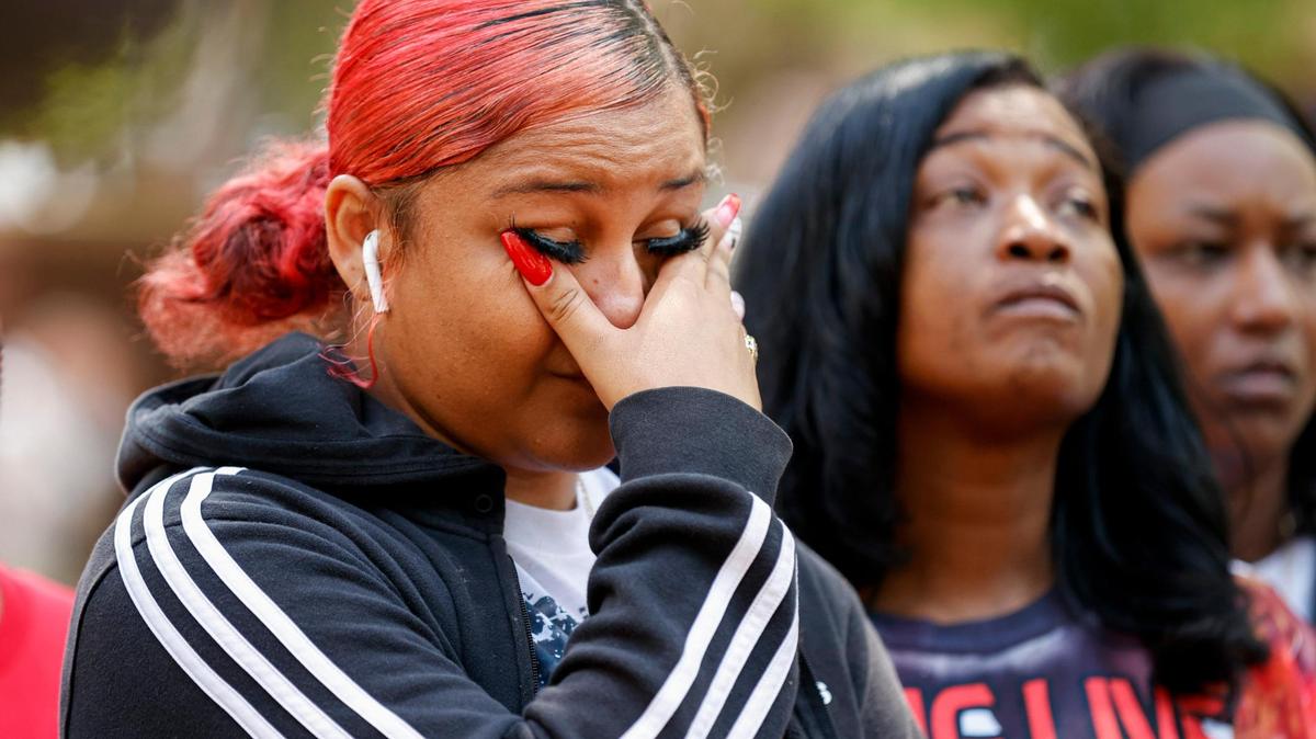 Cree Faulkner, left, cries as she and J’on Staton, center, stand at a press conference for Malcolm Staton outside the Union County Courthouse in Monroe on April 29, 2022.
