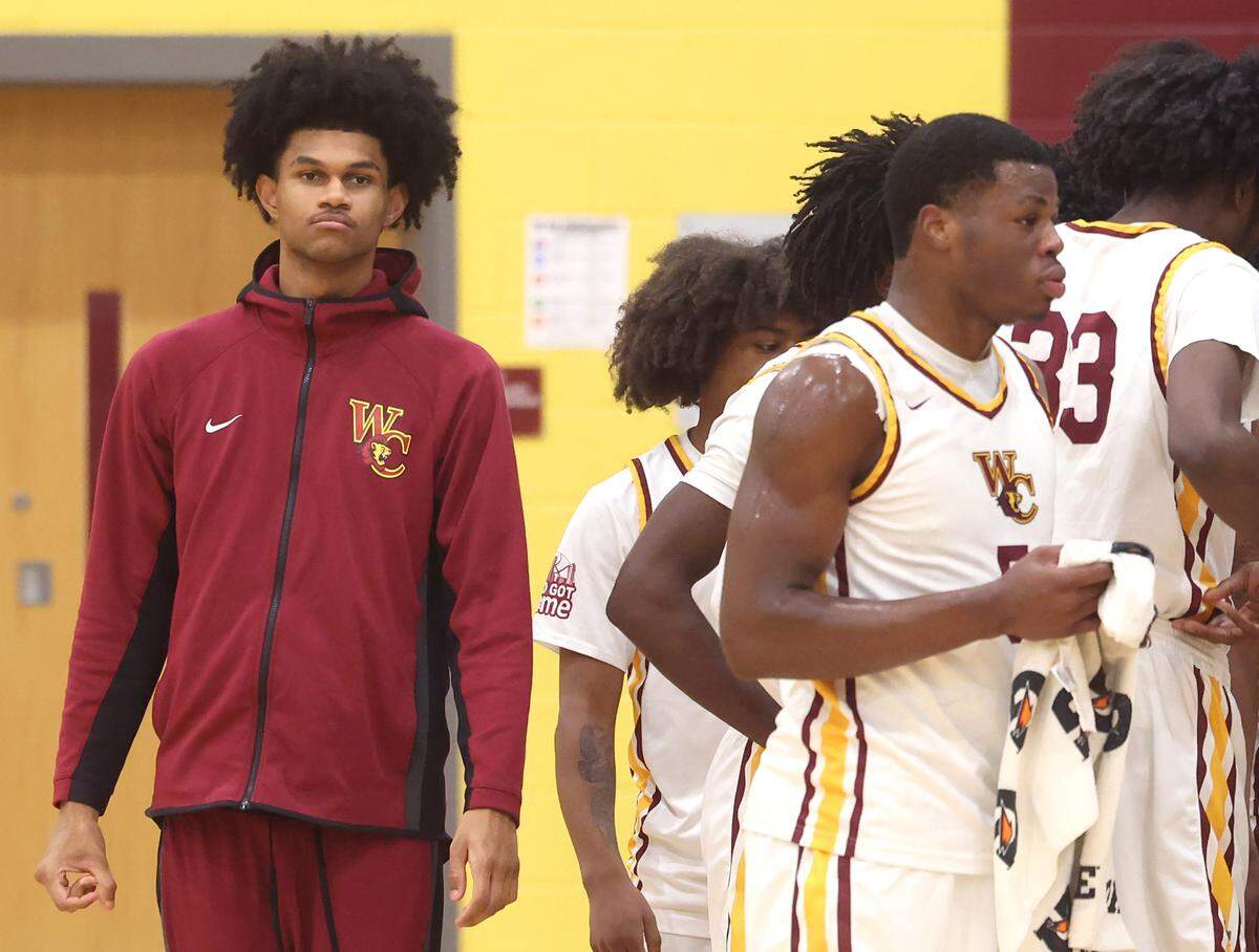 Janon Singh, left, walks to the West Charlotte Lions huddle during action against Hillside on Saturday, January 17, 2026. Singh, a junior is a top national recruit. West Charlotte hosted Hillside in a battle of traditionally black schools in the MLK Peace Basketball Showcase at West Charlotte High School in Charlotte, NC.
