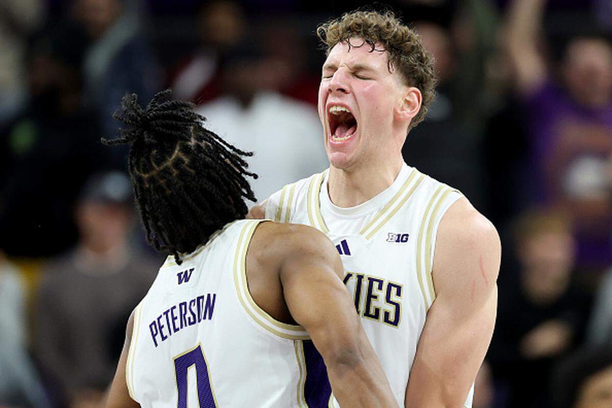 Quimari Peterson (left) and Hannes Steinbach (right) of the Washington Huskies react during the second half of a game at Alaska Airlines Arena.