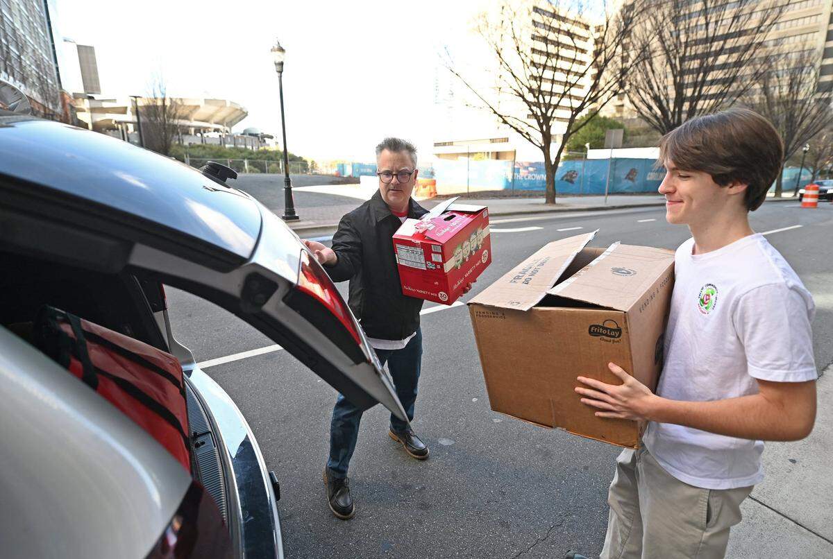 Brendan Kelly has used the help of his two sons — including Liam, at right — to try to address the issue of food insecurity in the Charlotte area. But he may soon be on his own.