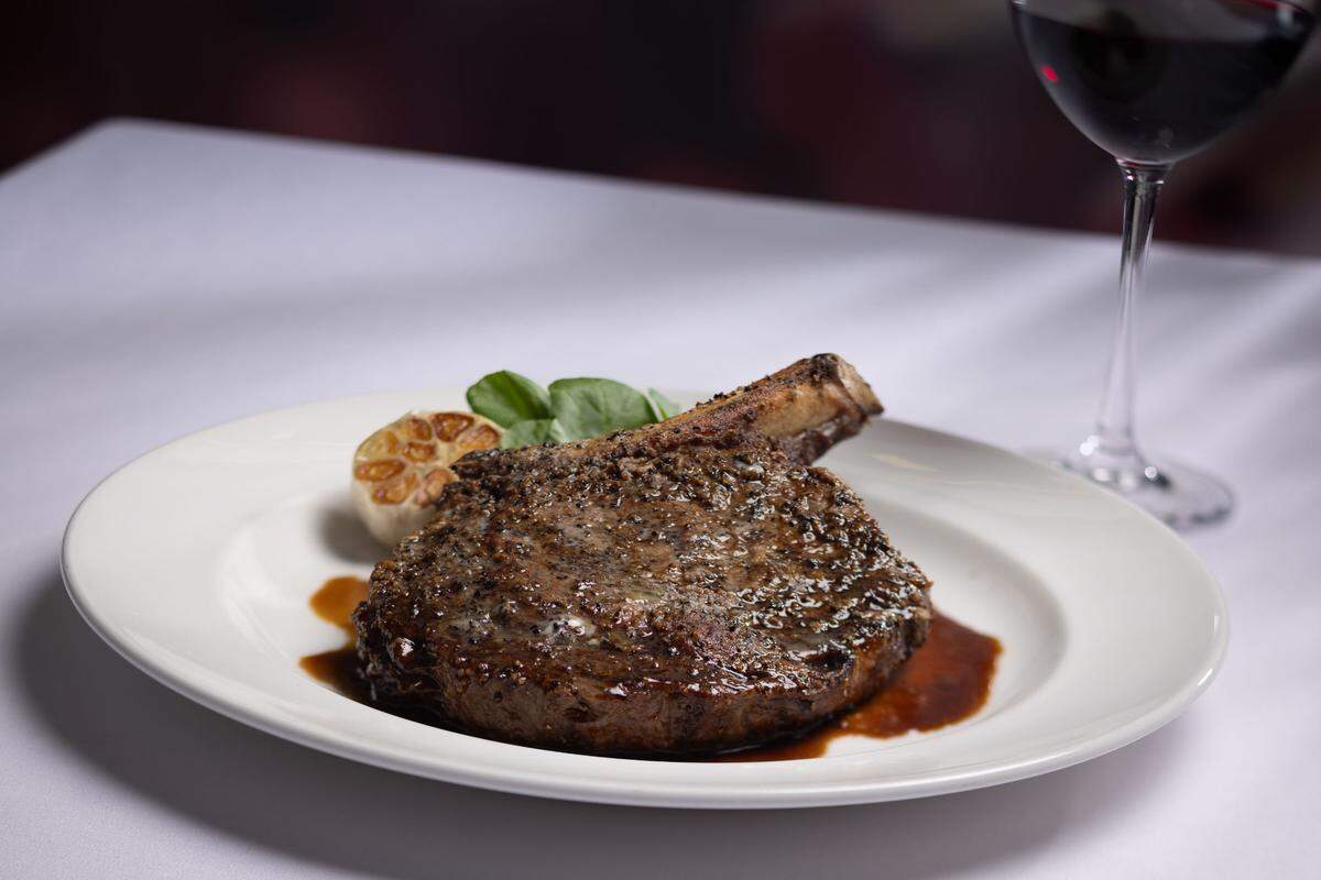 The Capital Grille’s 22 ounce prime bone-in ribeye with caramelized shallot jus and truffle butter.